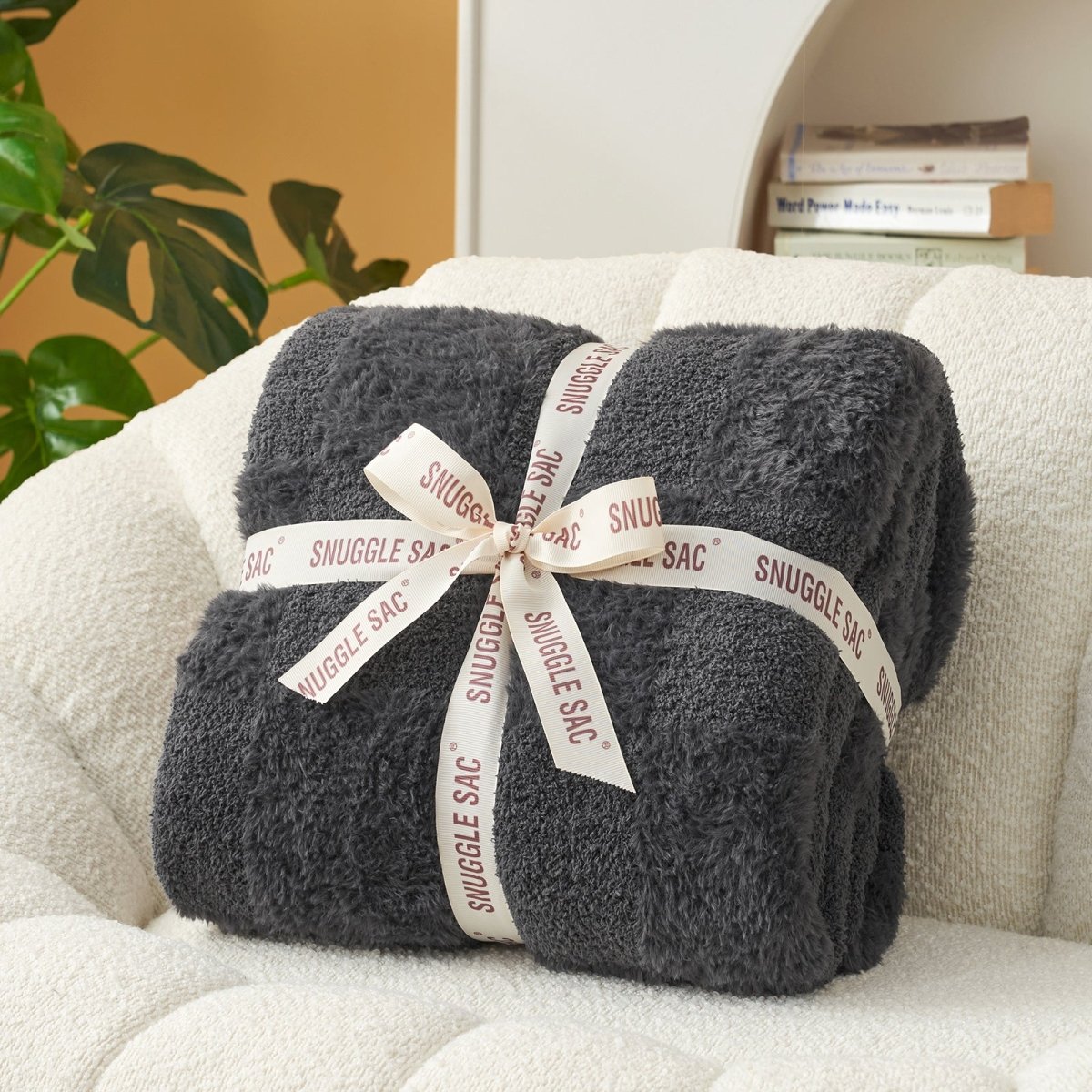 Checkered Faux Fur Feather Yarn Throw Blanket in Dark Grey neatly folded with ribbon, perfect for gifting. #color_Dark Grey