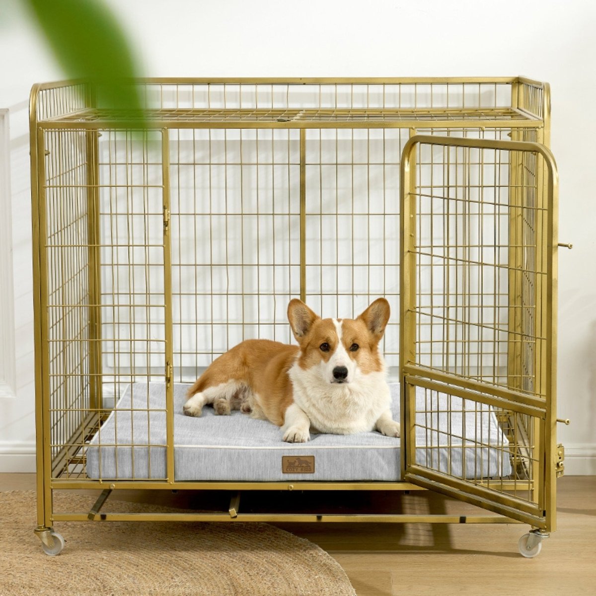 Dog lying on a cooling cushion inside a gold metal dog crate.#color_Light Grey