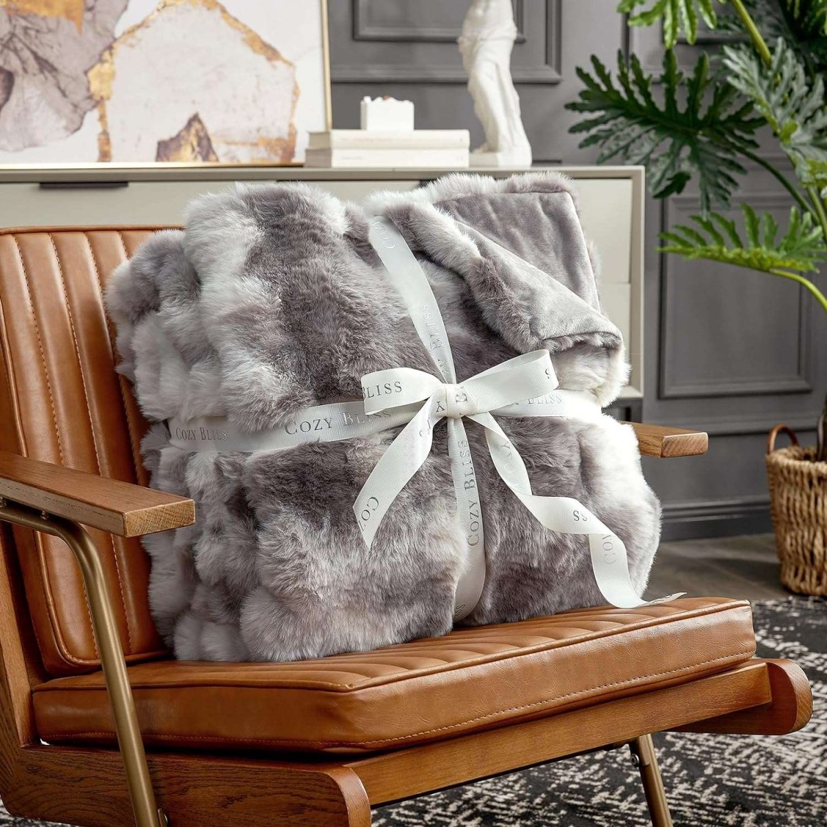 Fluffy tie-dye taupe blanket with a bow on an armchair. #color_Tie-dye Taupe