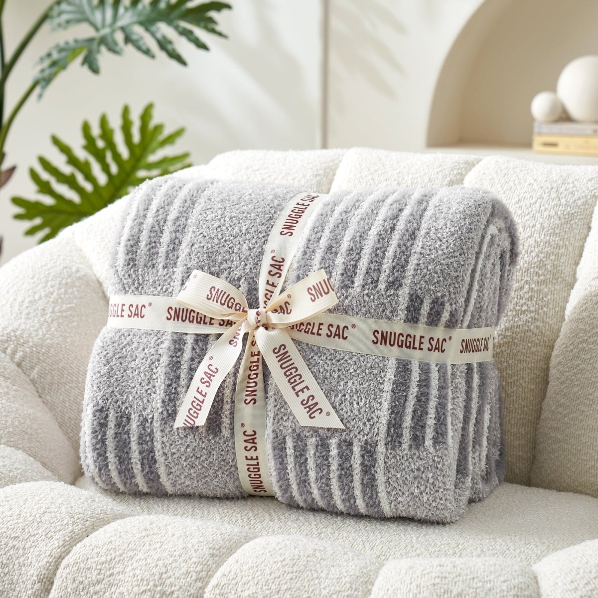 Reversible Heather Checkered Feather Yarn Throw Blanket in Grey neatly folded with ribbon, perfect as a cozy gift option. #color_Grey