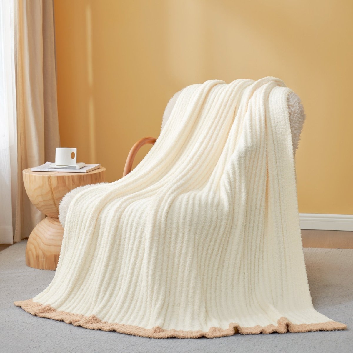 Soft Ribbed Feather Yarn Throw Blanket in Cream White draped over an armchair, showcasing ribbed texture and soft feather yarn design. #color_Cream White