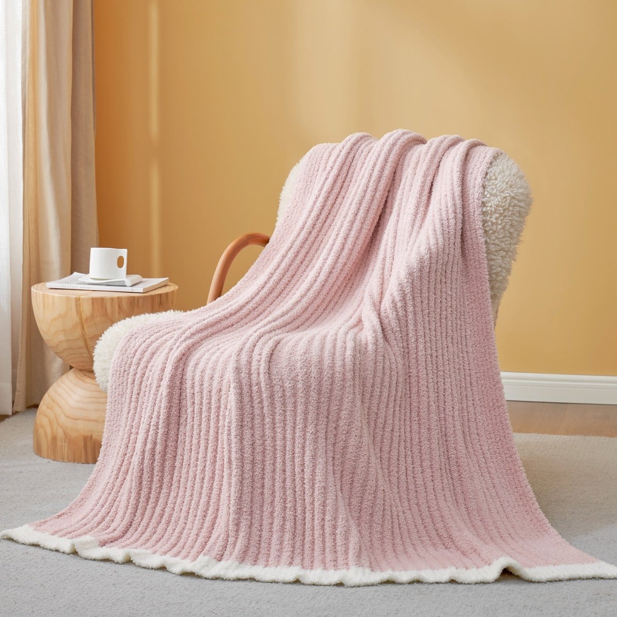 Soft Ribbed Feather Yarn Throw Blanket in Pink draped over an armchair, showcasing ribbed texture and soft feather yarn design. #Color_Pink