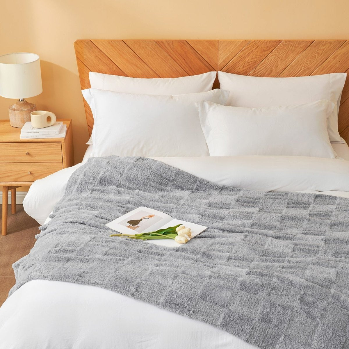 Checkered Faux Fur Feather Yarn Throw Blanket in Light Grey styled on a bed, adding a cozy touch. #Color_Light Grey