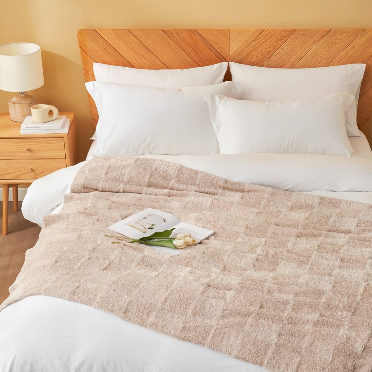 Checkered Faux Fur Feather Yarn Throw Blanket in Beige styled on a bed, adding a soft layered look. #color_Beige