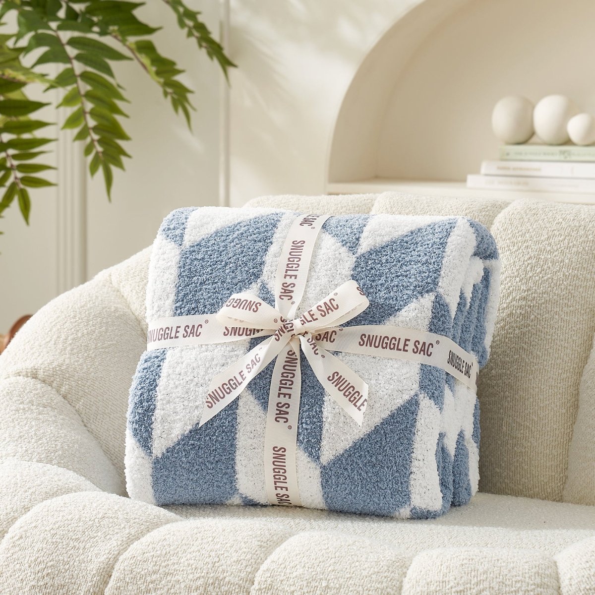 Chevron Feather Yarn Knit Throw Blanket in Blue neatly folded with ribbon packaging, perfect as a cozy gift for holidays and special occasions. #color_Misty Blue