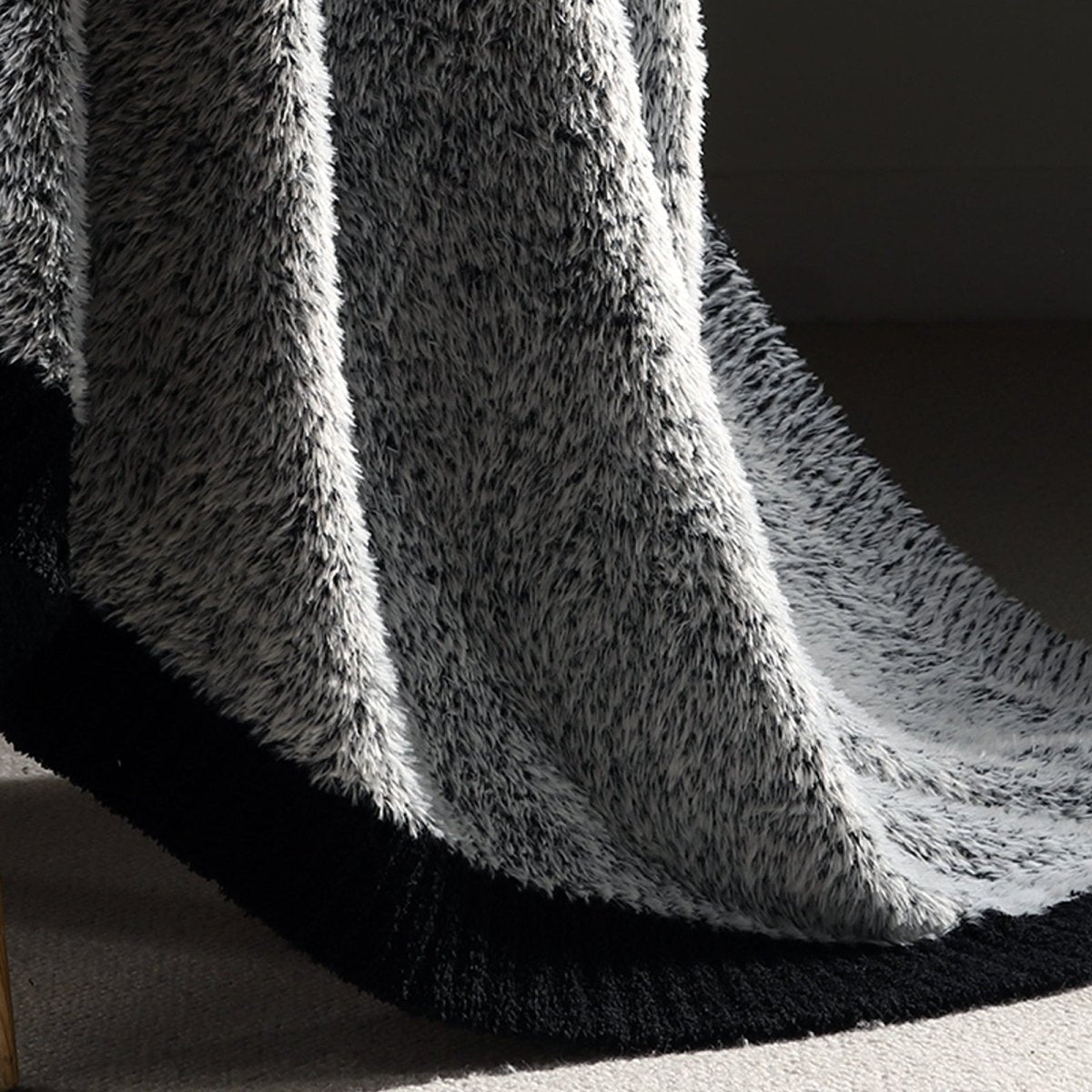 Close-up of plush feather yarn on Faux Mink Feather Knit Throw Blanket in Black highlighting dense and soft fabric texture. #color_Black
