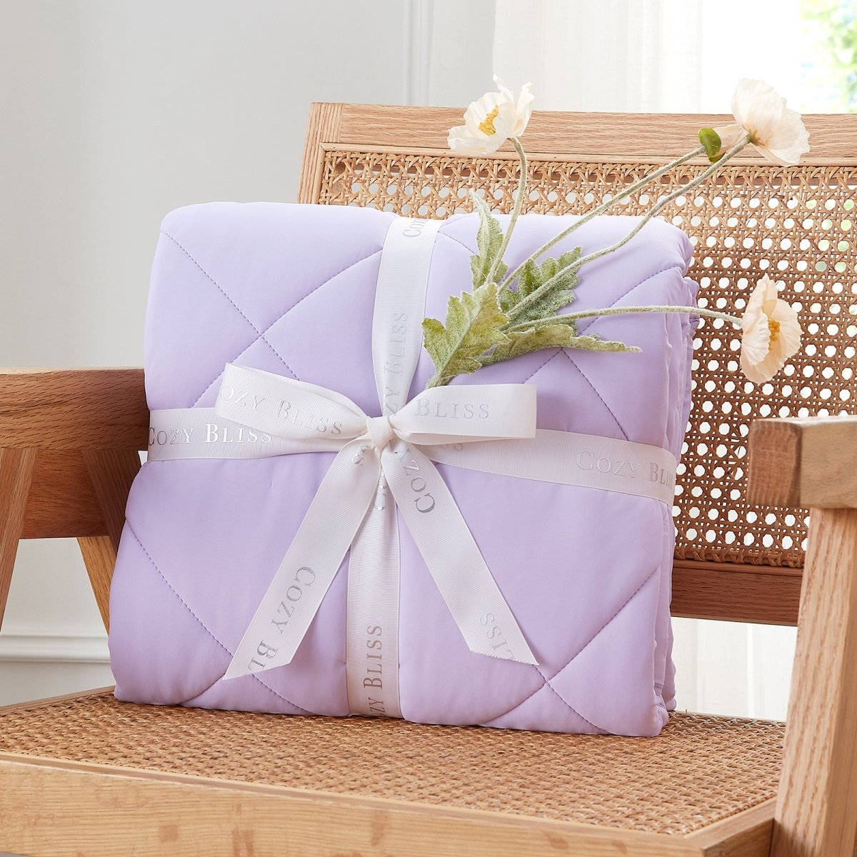 Purple quilt with a white ribbon on a wooden chair  #color_Purple