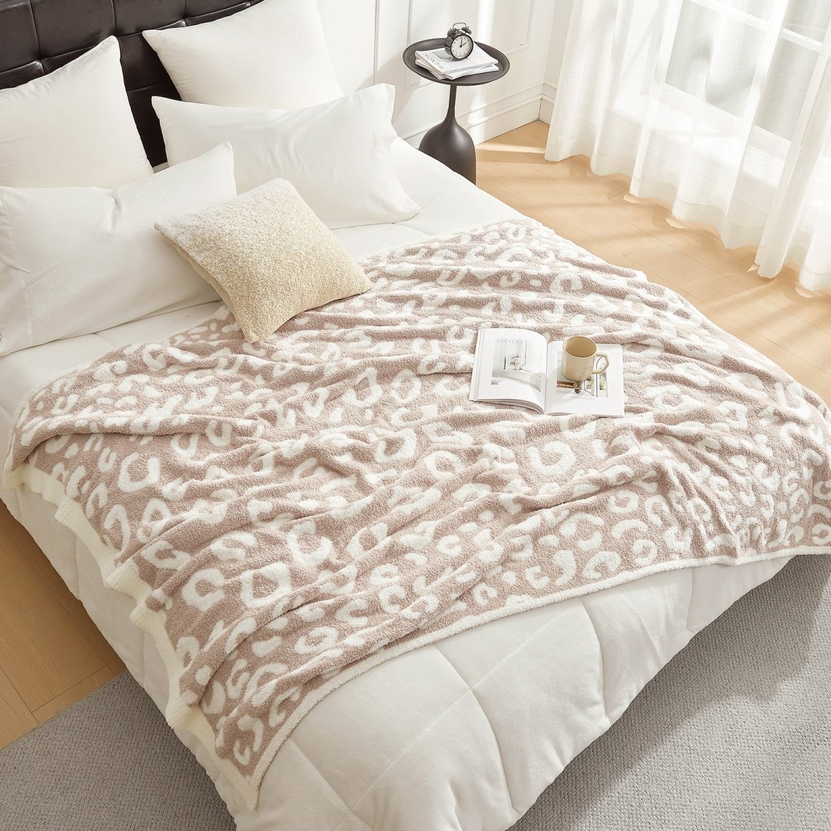 Reversible Leopard Feather Yarn Throw Blanket in Khaki Leopard styled on a bed, adding a warm and elegant layered look. #color_Khaki Leopard