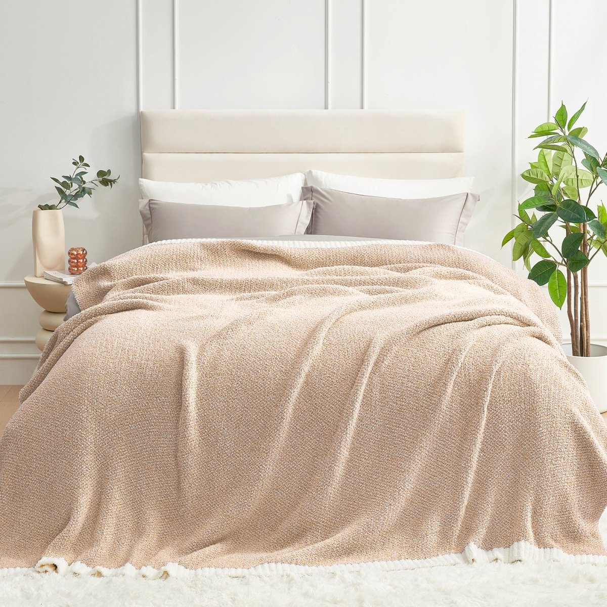 Heather Feather Yarn Throw Blanket in beige styled on a bed, enhancing bedroom decor with a soft, elegant and cozy layered look. #Color_Beige