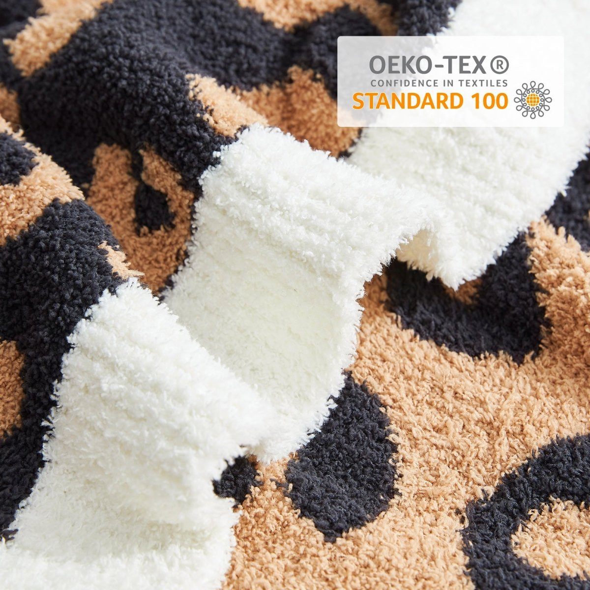 Close-up of Reversible Leopard Feather Yarn Throw Blanket in Brown Leopard showcasing soft texture and OEKO-TEX STANDARD 100 certification. #color_Brown Leopard
