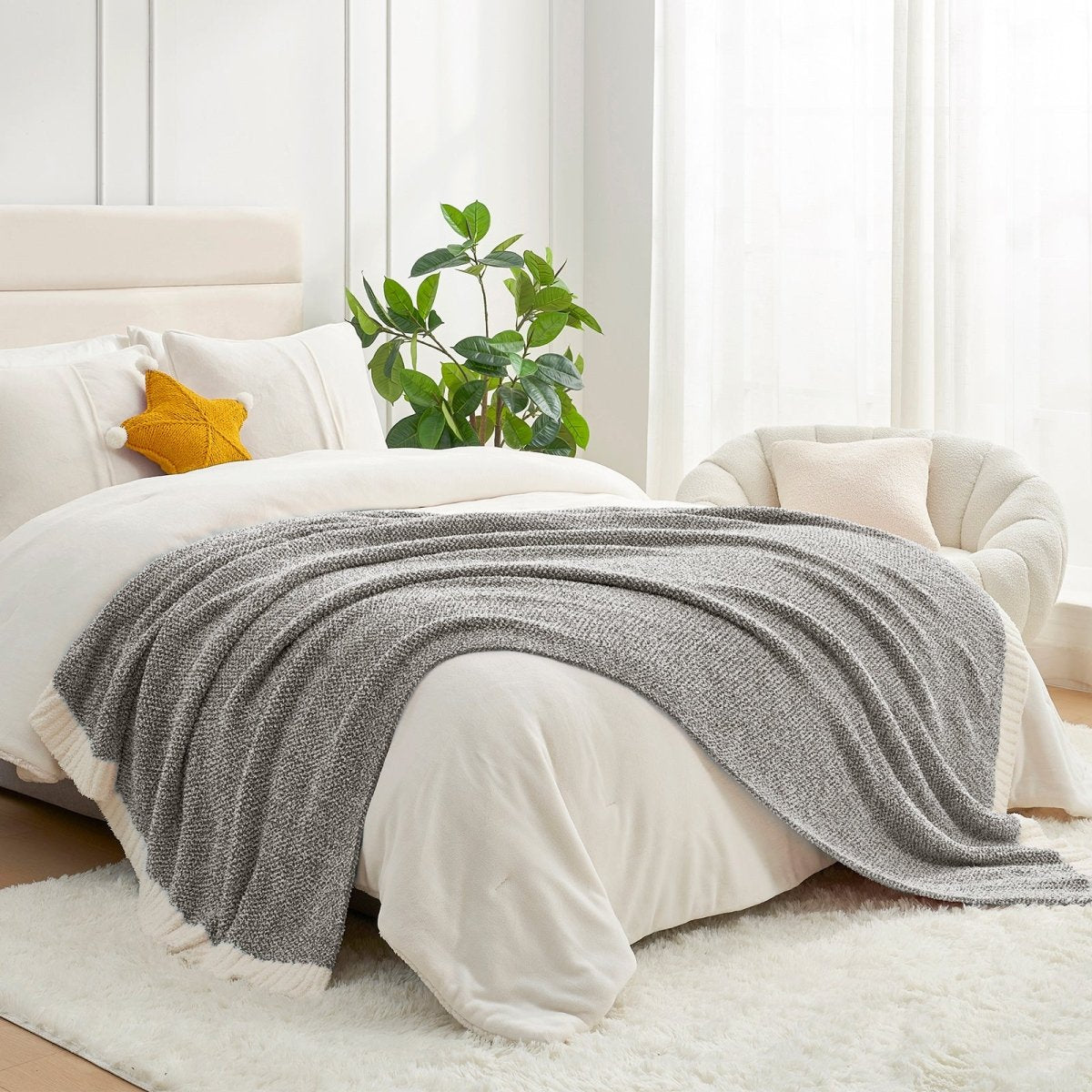 Heather Feather Yarn Throw Blanket in dark grey styled on a bed, enhancing bedroom decor with a soft, elegant and cozy layered look. #color_Dark Grey
