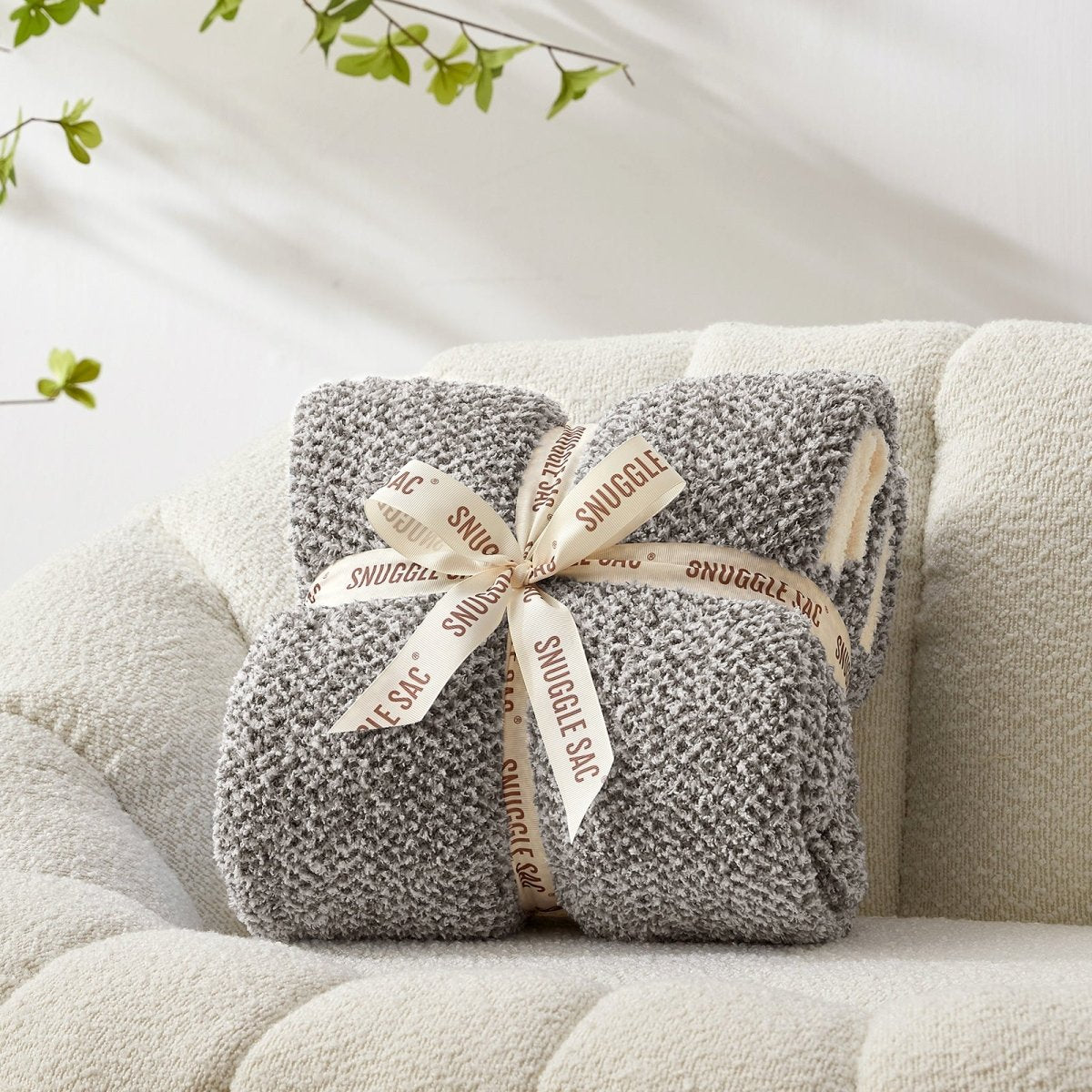 Heather Feather Yarn Throw Blanket in dark grey neatly folded with ribbon, a perfect gift idea for holidays, housewarming or special occasions. #color_Dark Grey