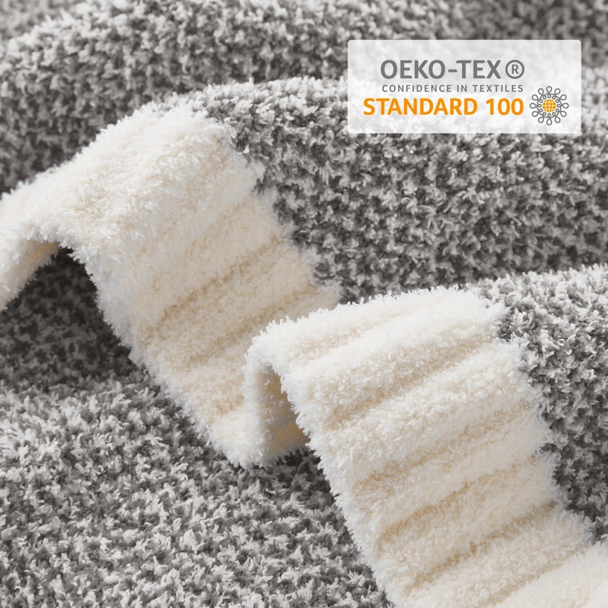 Close-up of Heather Feather Yarn Throw Blanket in Dark Grey showcasing plush texture and OEKO-TEX STANDARD 100 certification. #color_Dark Grey