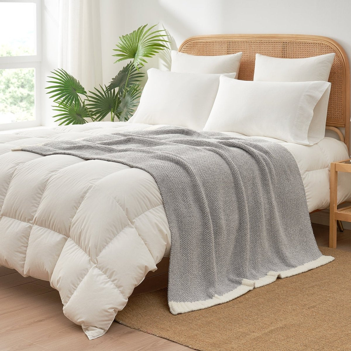 Heather Feather Yarn Throw Blanket in grey styled on a bed, enhancing bedroom decor with a soft, elegant and cozy layered look. #Color_Grey