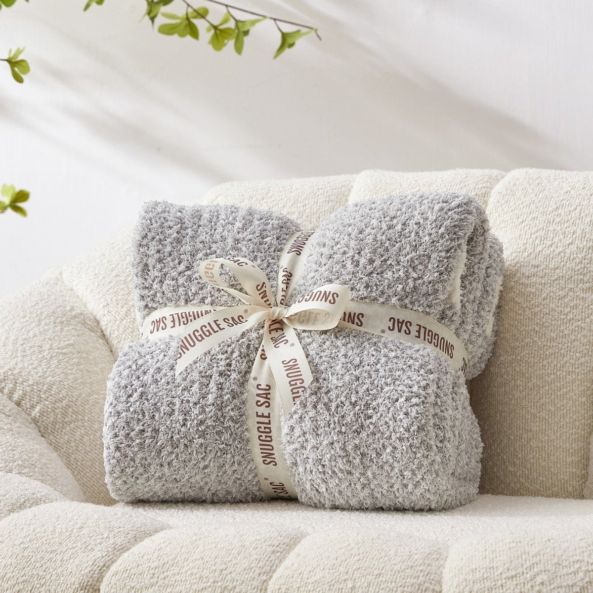 Heather Feather Yarn Throw Blanket in grey neatly folded with ribbon, a perfect gift idea for holidays, housewarming or special occasions. #Color_Grey