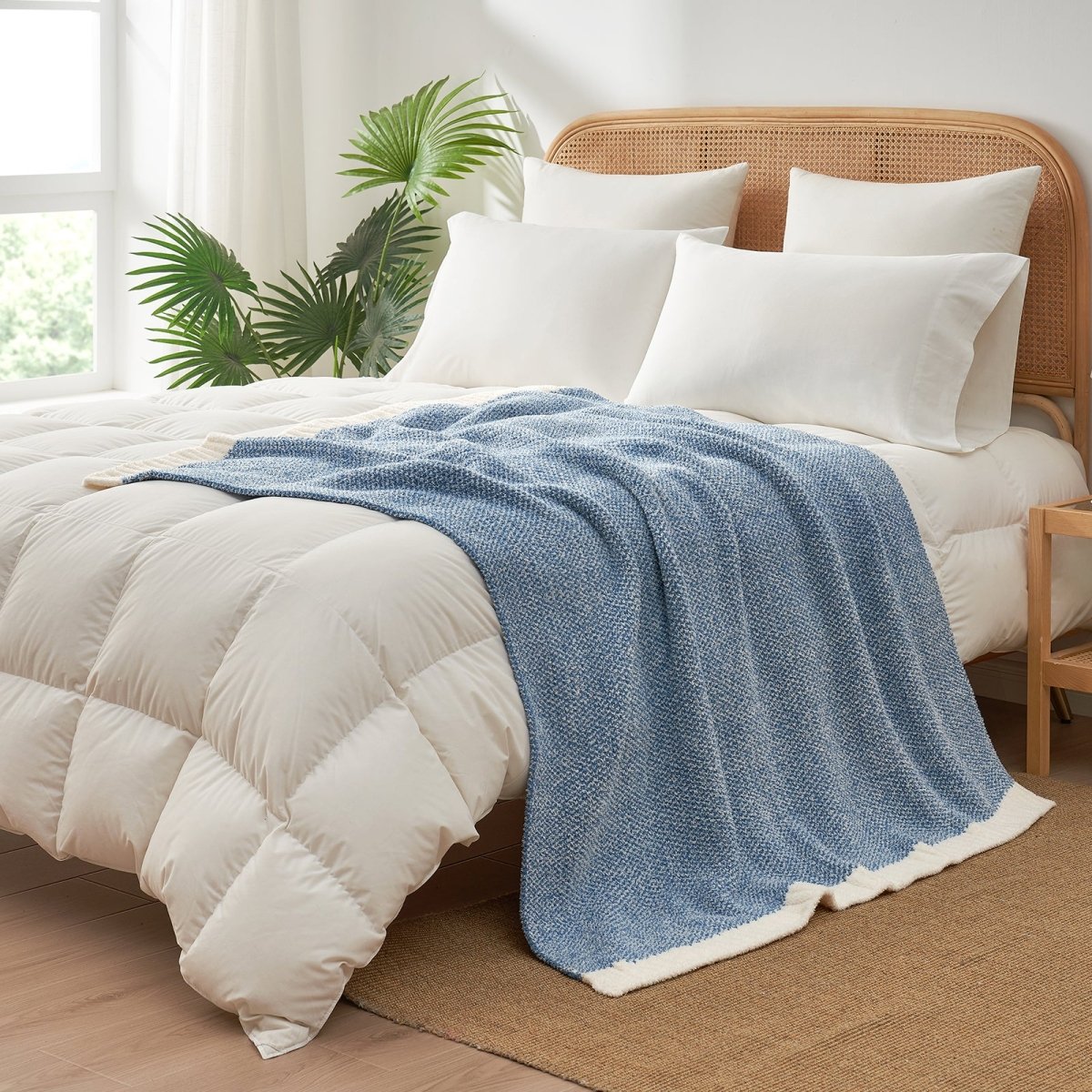 Heather Feather Yarn Throw Blanket in misty blue styled on a bed, enhancing bedroom decor with a soft, elegant and cozy layered look.  #Color_Misty Blue