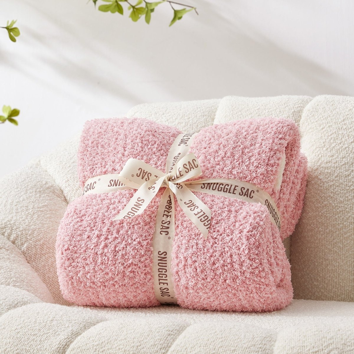 Heather Feather Yarn Throw Blanket in pink neatly folded with ribbon, a perfect gift idea for holidays, housewarming or special occasions.  #Color_Pink