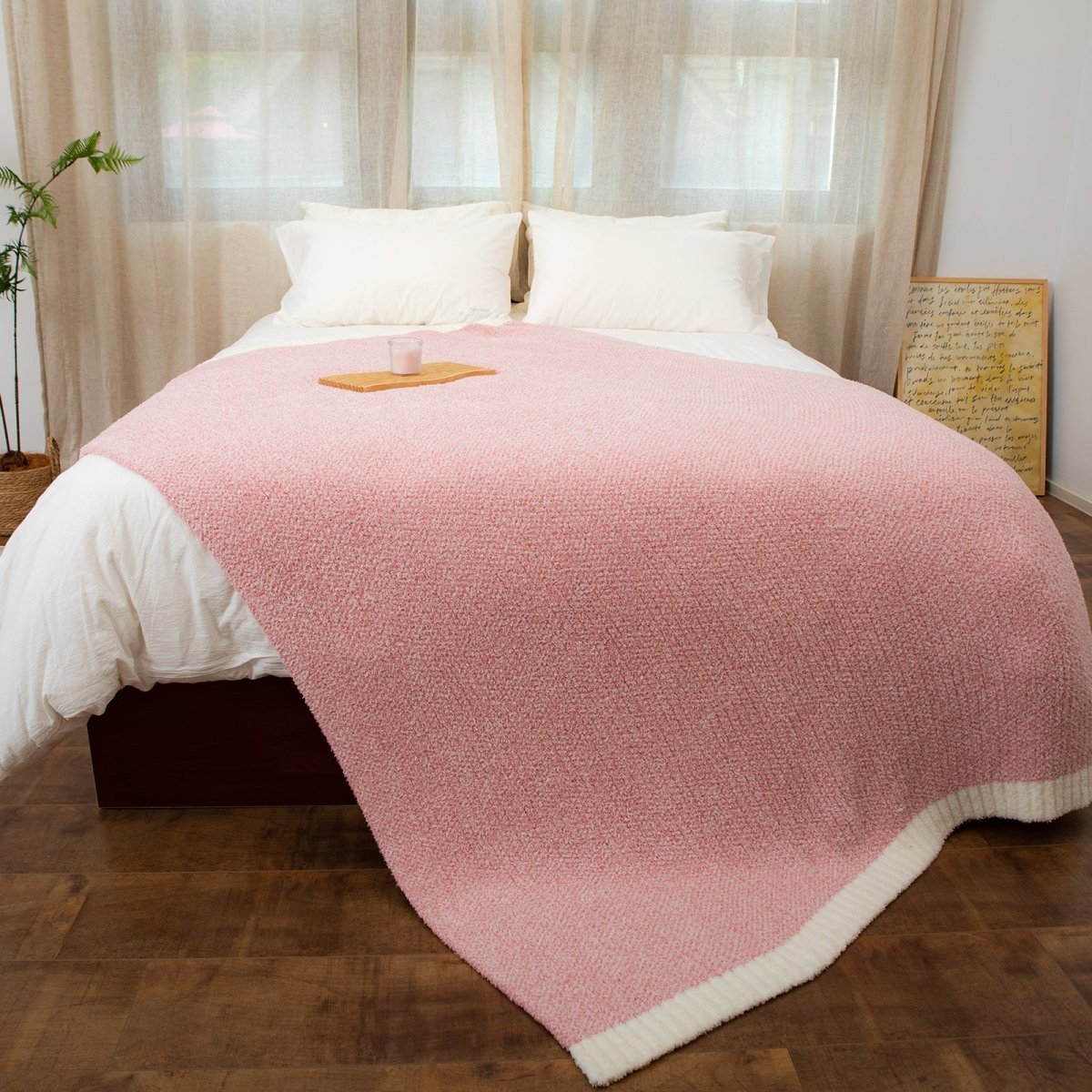 Heather Feather Yarn Throw Blanket in pink styled on a bed, enhancing bedroom decor with a soft, elegant and cozy layered look.  #Color_Pink