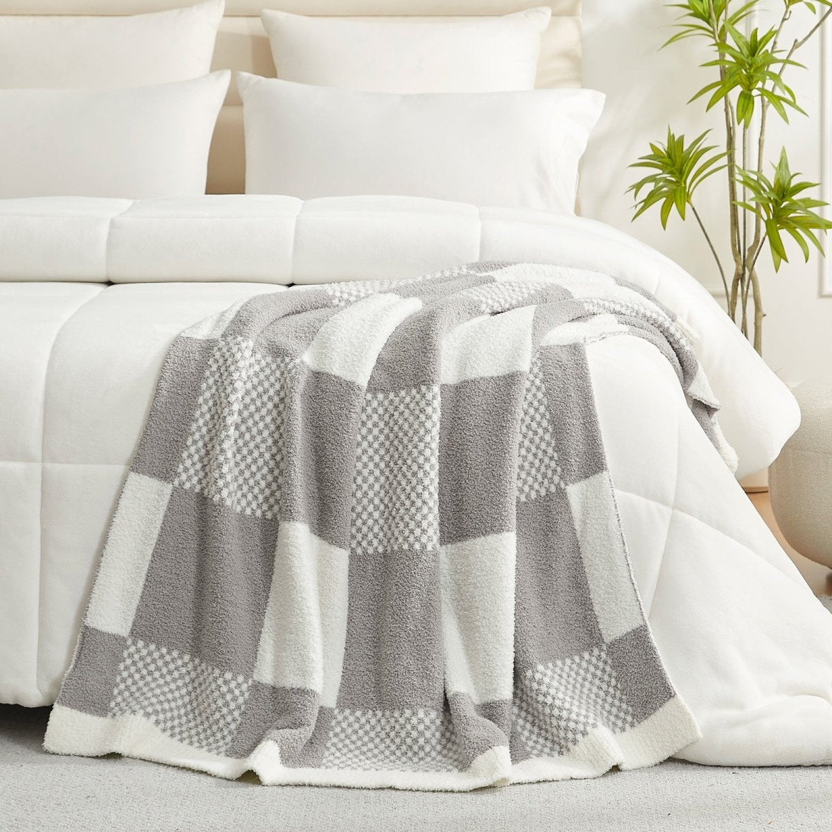 Checkered Feather Yarn Throw Blanket in Grey styled on a bed, adding a clean and cozy layered look to bedroom decor. #color_Grey
