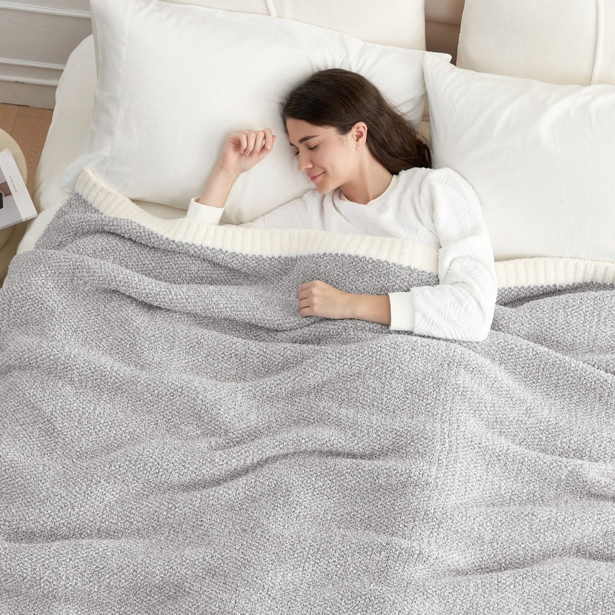 Woman sleeping under a Heather Feather Yarn Throw Blanket in grey, offering breathable warmth and a cozy sleep experience. #Color_Grey
