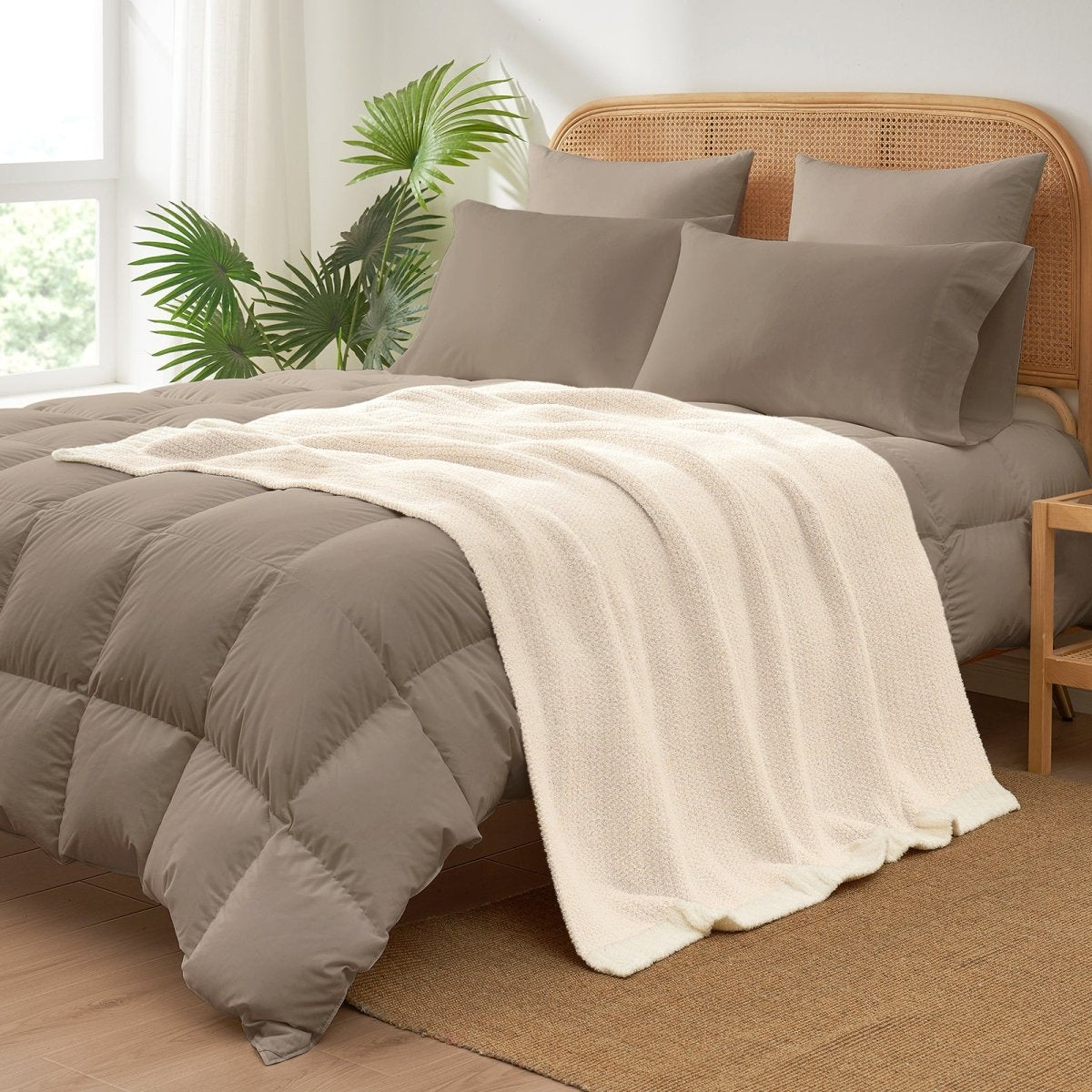 Heather Feather Yarn Throw Blanket in Ivory styled on a bed, enhancing bedroom decor with a soft, elegant and cozy layered look. #color_Ivory
