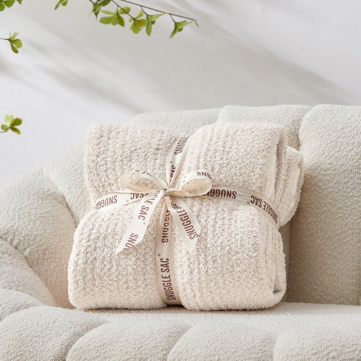 Heather Feather Yarn Throw Blanket in Ivory neatly folded with ribbon, a perfect gift idea for holidays, housewarming or special occasions. #color_Ivory