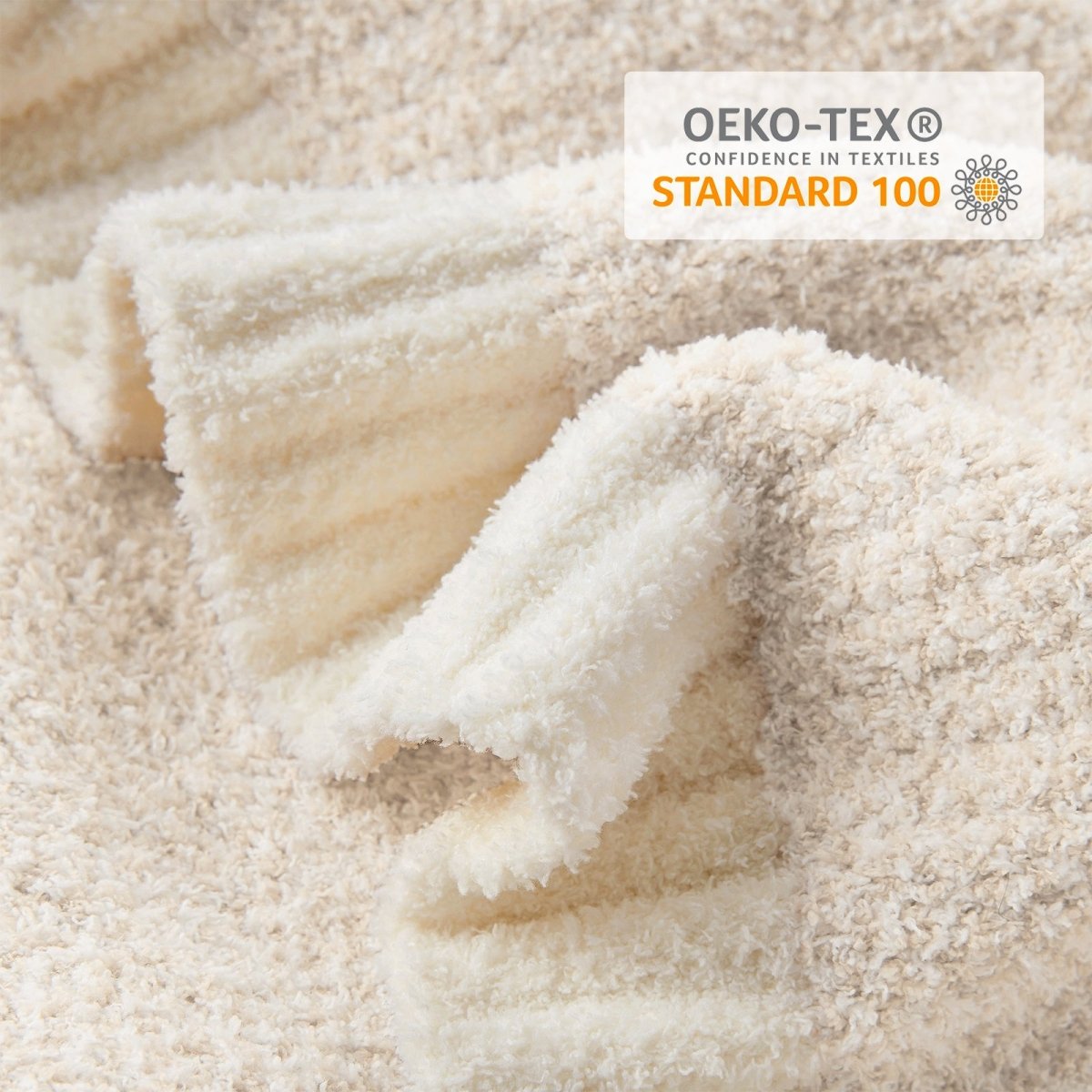 Close-up of Heather Feather Yarn Throw Blanket highlighting its plush feather yarn texture and OEKO-TEX STANDARD 100 certification. #color_Ivory