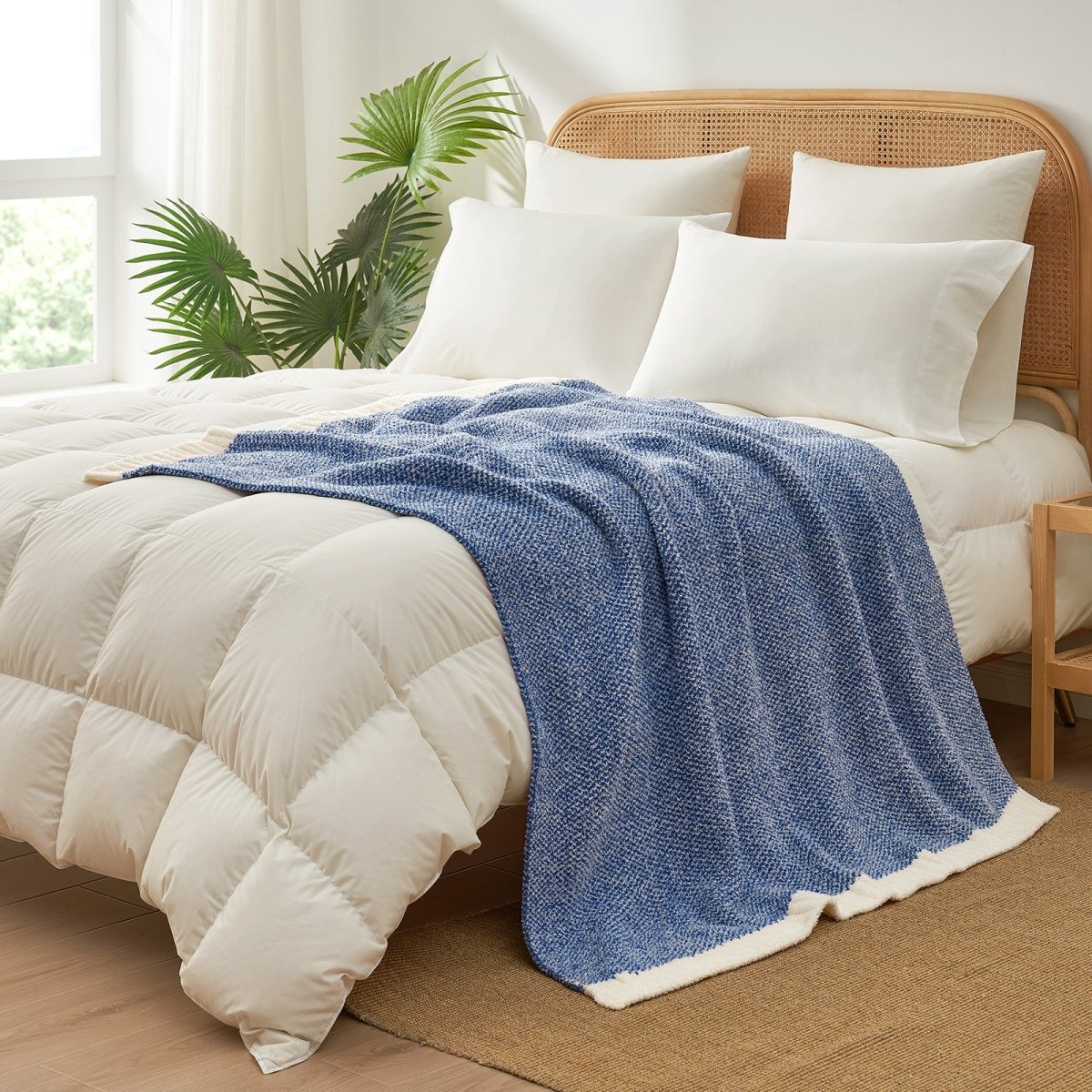 Heather Feather Yarn Throw Blanket in dark blue styled on a bed, enhancing bedroom decor with a soft, elegant and cozy layered look. #Color_Dark Blue