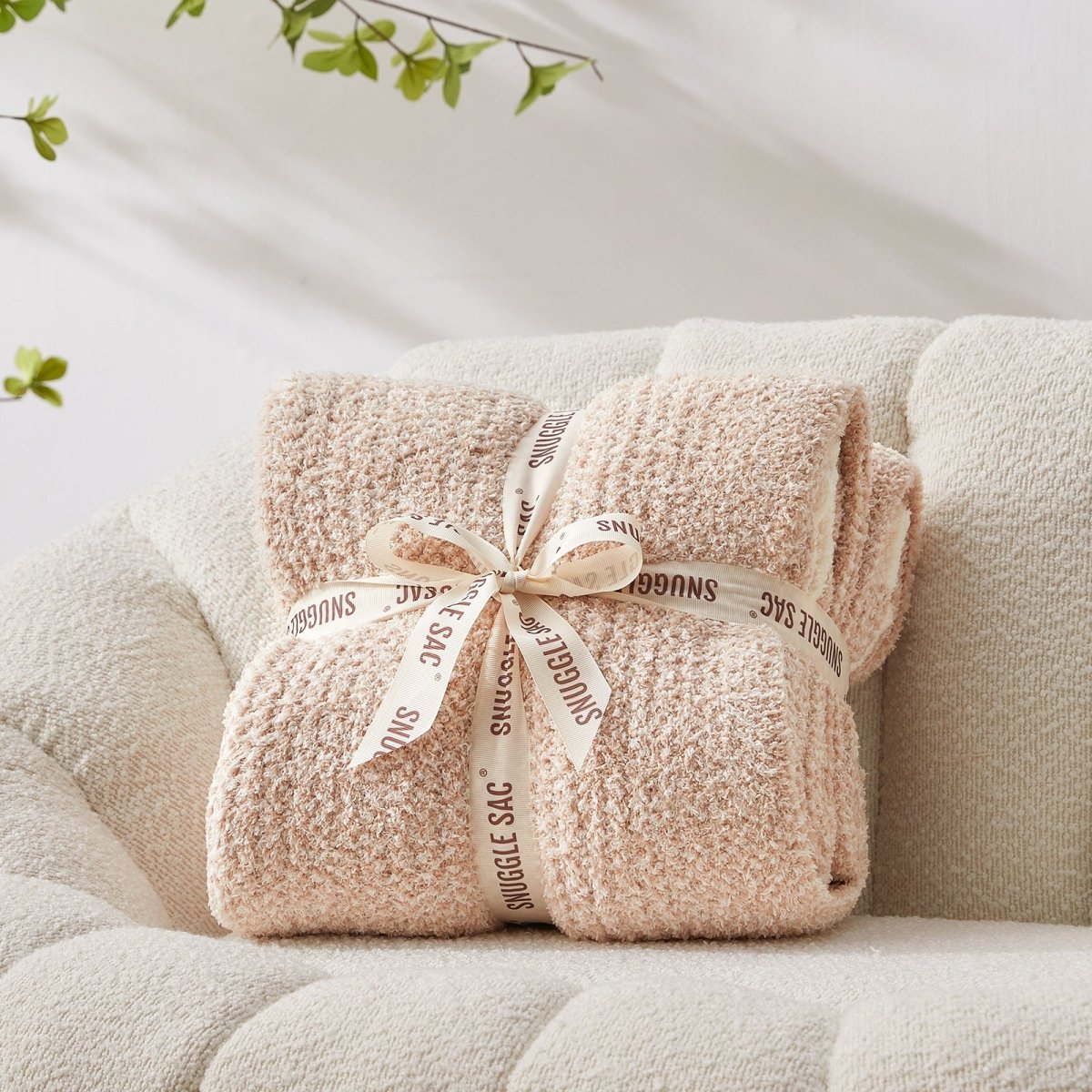 Heather Feather Yarn Throw Blanket in beige neatly folded with ribbon, a perfect gift idea for holidays, housewarming or special occasions. #Color_Beige