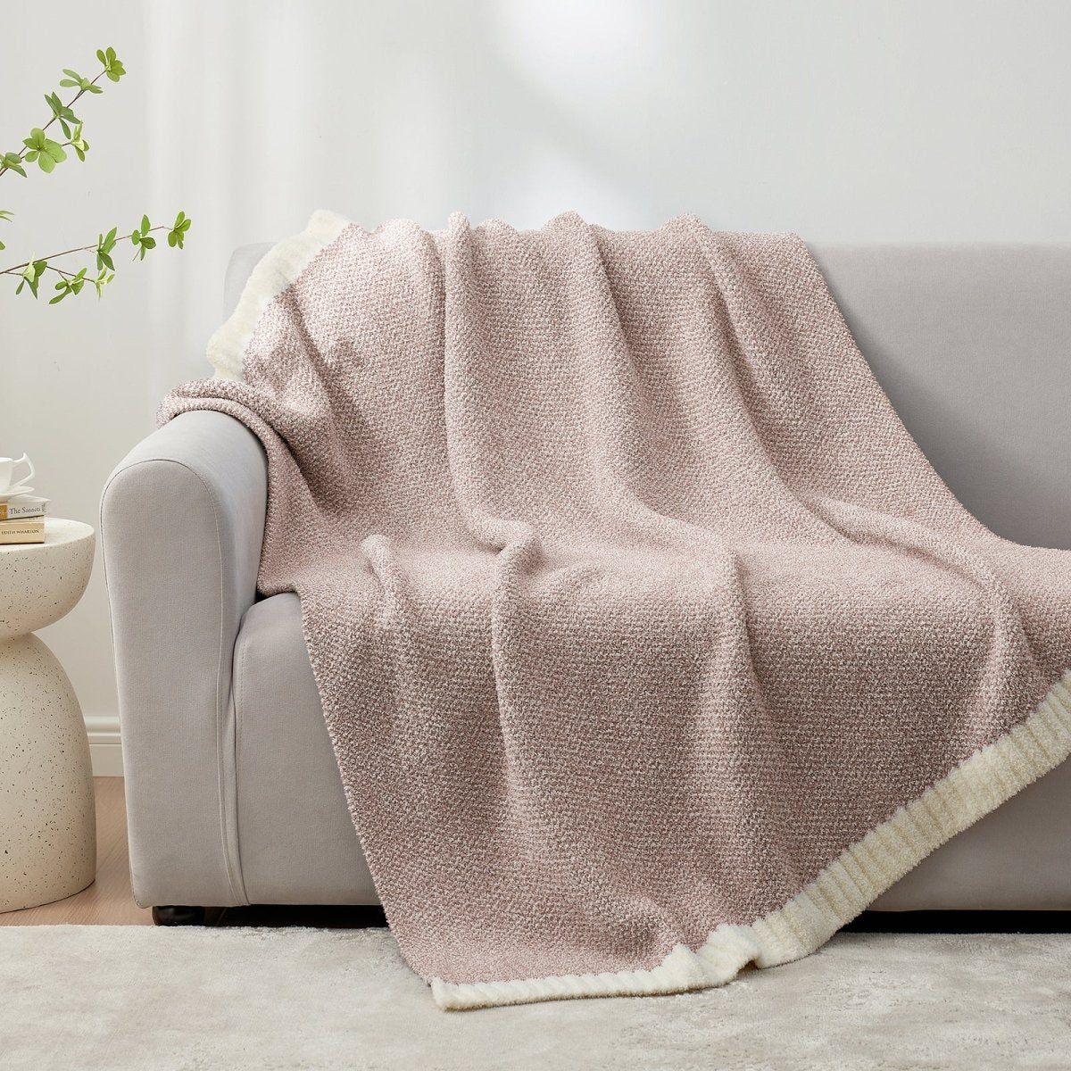 Heather Feather Yarn Throw Blanket in Brown draped over a sofa, adding warmth and a cozy feel. #color_Light Brown