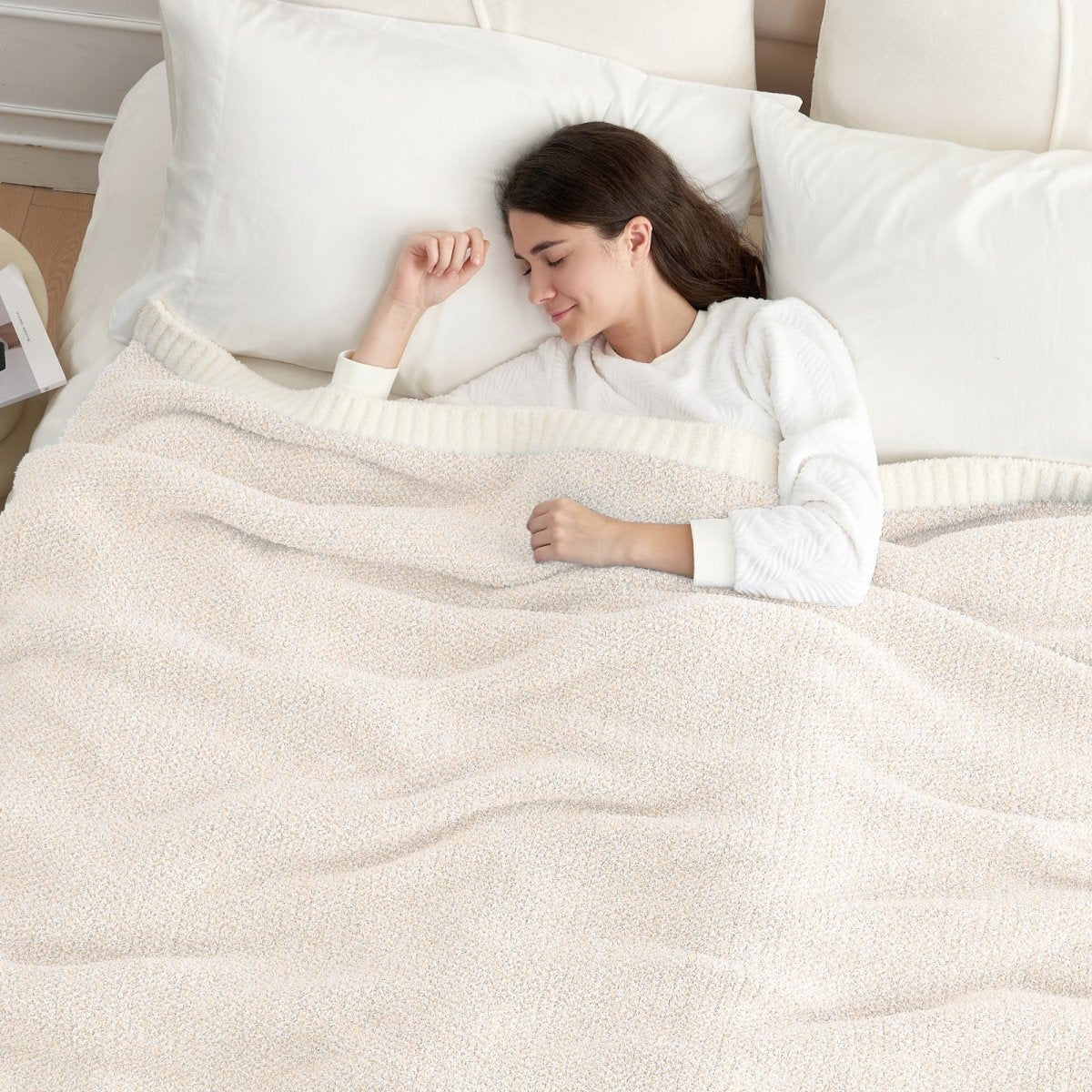 Woman sleeping under a Heather Feather Yarn Throw Blanket in Ivory, offering breathable warmth and a cozy sleep experience. #color_Ivory