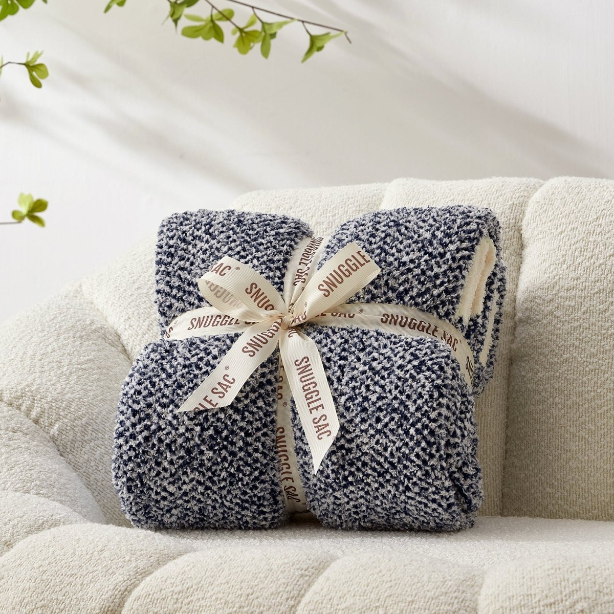 Heather Feather Yarn Throw Blanket in navy blue neatly folded with ribbon, a perfect gift idea for holidays, housewarming or special occasions.  #Color_Navy Blue