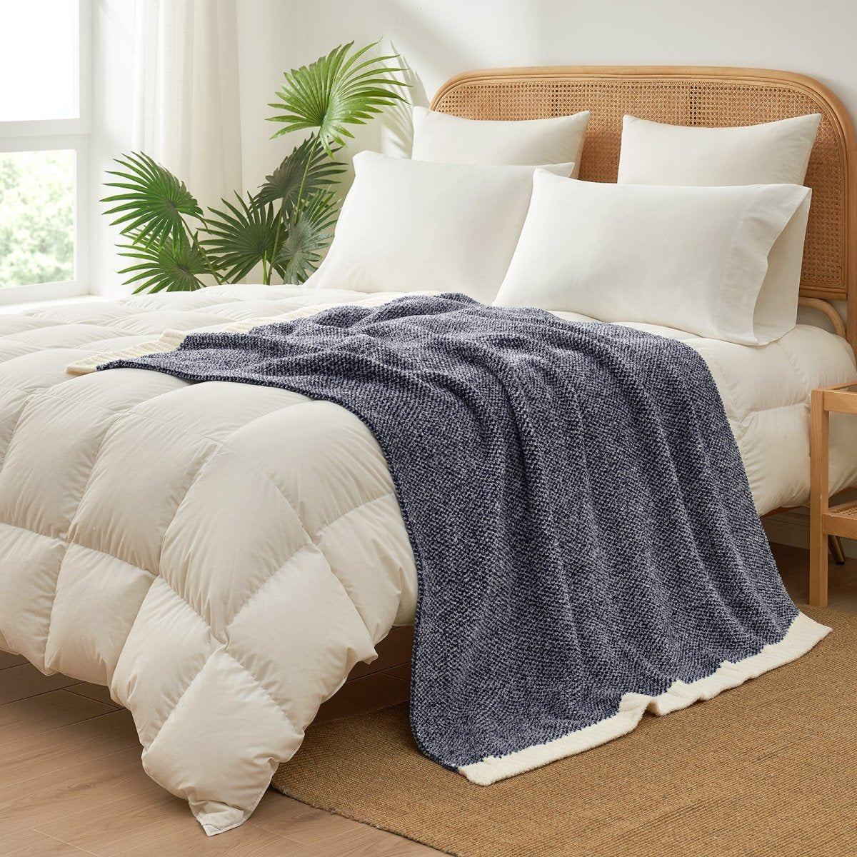 Heather Feather Yarn Throw Blanket in navy blue styled on a bed, enhancing bedroom decor with a soft, elegant and cozy layered look.  #Color_Navy Blue