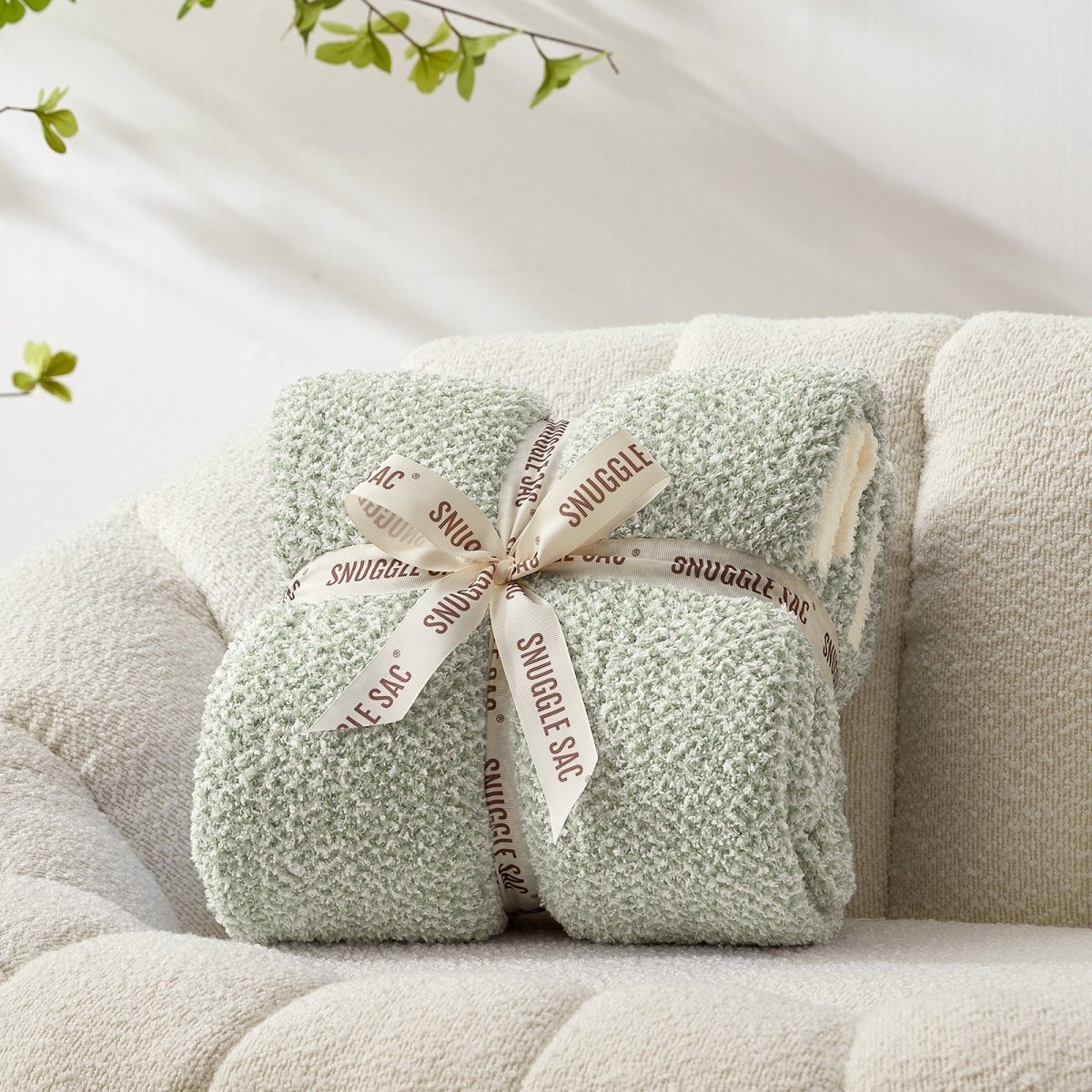 Heather Feather Yarn Throw Blanket in sage green neatly folded with ribbon, a perfect gift idea for holidays, housewarming or special occasions.  #Color_Sage Green