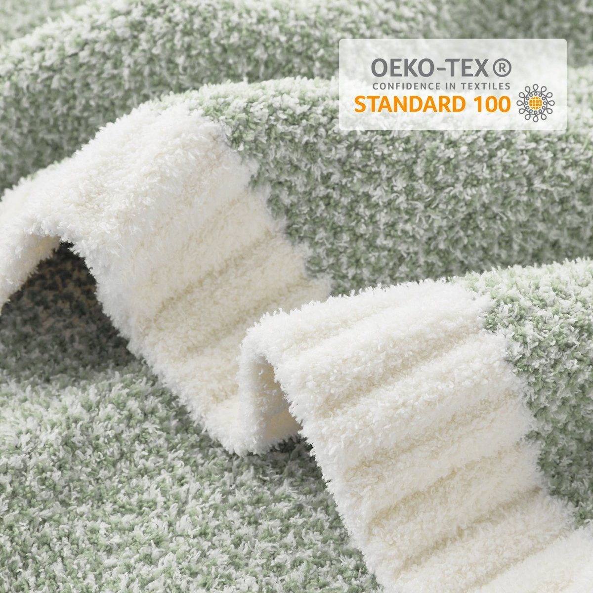 Close-up of Heather Feather Yarn Throw Blanket in Sage Green showcasing plush texture and OEKO-TEX STANDARD 100 certification. #color_Sage Green